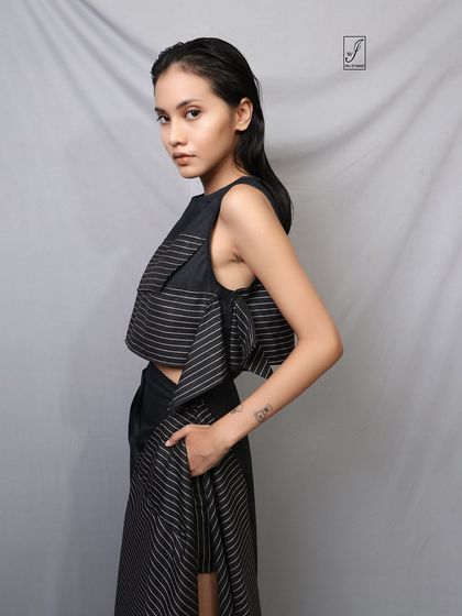 A beautiful and simple close-up that emphasizes the model's features and the clean lines of the top.