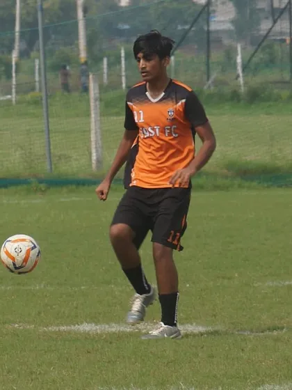 A U16 player demonstrating ball control, settling the ball from the air during an RSA Cup match.
