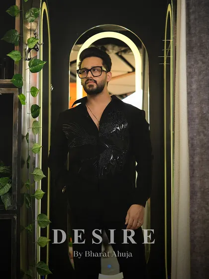 A full-length view of the black-on-black embroidered shirt, a perfect example of ultra-luxe menswear.