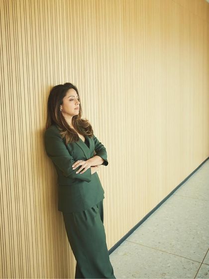 A wide shot that uses the clean lines of the architecture to complement the sharp tailoring of the suit.