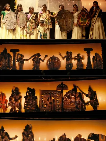 The captivating play of light and shadow in a 'Tholpavakoothu' or shadow puppetry performance. This ancient art form from Southern India uses translucent leather puppets to create mystical silhouettes against a screen, narrating stories from the great epics. Here you can see the intricate details of the puppets and the artists who manipulate them.