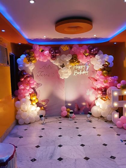The same fairy theme setup, showing how the lighting and balloon placement can transform a simple room into a magical space.