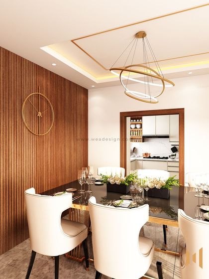 The dining area in this modern luxury home features a sleek black dining table and a striking fluted wood wall, creating a sophisticated space for meals.