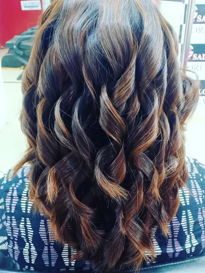 Bouncy curls are the perfect way to show off fresh highlights. The light catches the different tones, creating a stunning, dimensional effect.