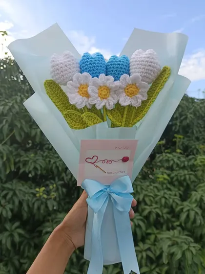 A custom-wrapped bouquet of blue tulips and white daisies.