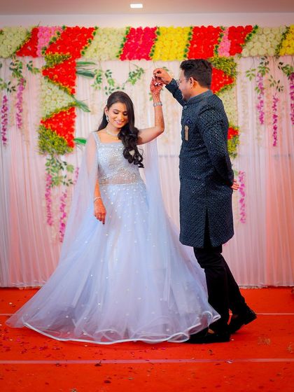 A fun, dancing pose that captures the celebratory mood of the event.