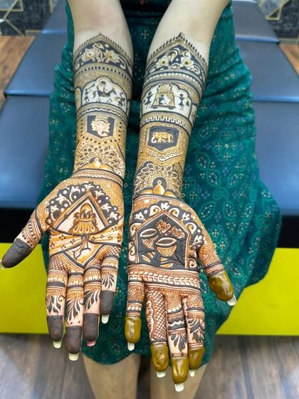 A traditional design with a focus on auspicious symbols. This bridal mehndi includes kalash motifs, elephants, and intricate check patterns for a classic look.