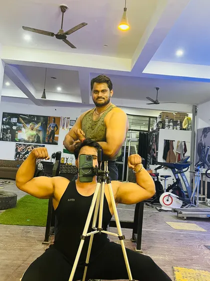A classic gym mirror selfie with my big brother. We are powerlifters who train hard together.