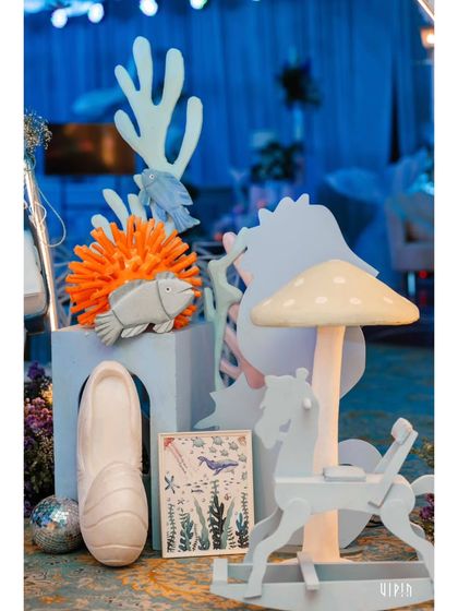 A collection of whimsical, pastel-colored props that add to the dreamy ocean theme. I love mixing different elements like a rocking horse and mushrooms to create a unique, fantasy-inspired look.