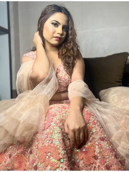 This peach-colored lehenga with a ruffled dupatta is a soft and romantic choice for an engagement or a friend's wedding.