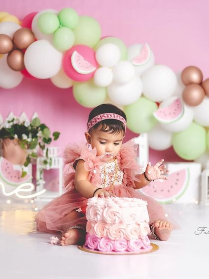 A beautiful cake for a beautiful one-year-old. The watermelon theme is carried through from the balloons to the cake itself.