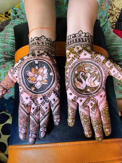 A beautiful design featuring a lotus in a central circle on one hand and two swans on the other. This kind of symbolic and personalized art is perfect for any festive occasion.
