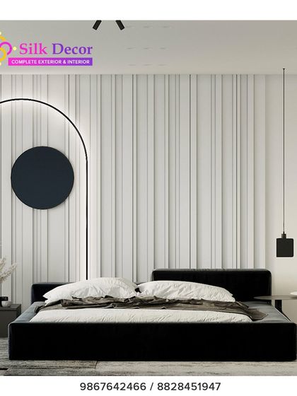 A bold, minimalist bedroom centered around our custom black platform bed. The stark, simple frame provides a strong anchor for the room, contrasting with the textured white wall and demonstrating our versatility in modern design styles.