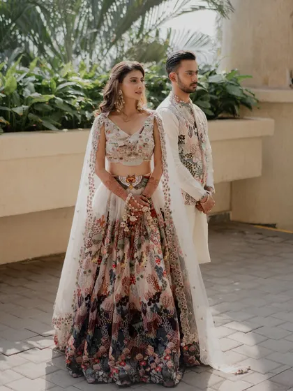 A vibrant carnival-themed look for Yashvi. The makeup is fresh and colorful, with a focus on glowing skin, complementing her floral Anshul Jain lehenga.
