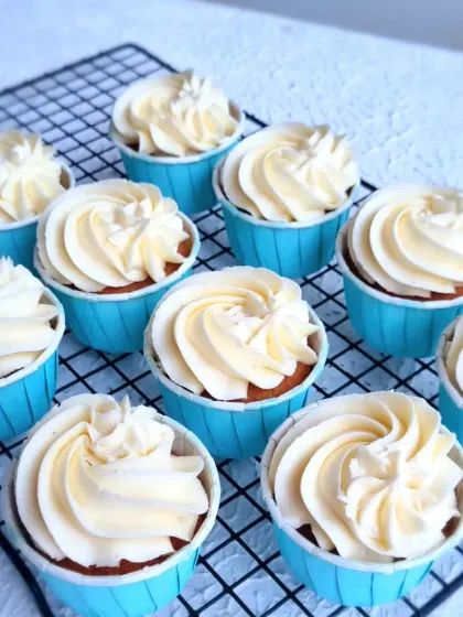 Simple vanilla cupcakes with buttercream frosting, ready to be decorated for the carnival-themed party.