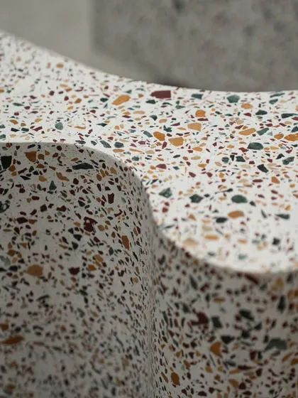 The wavy, sculptural form of the terrazzo bookshelf allows it to be both a functional storage unit and a captivating art piece, demonstrating how we can turn everyday objects into something extraordinary.