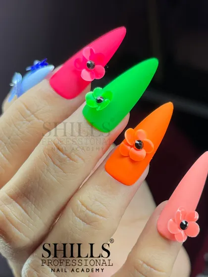 Bold and beautiful. This set features vibrant neon stiletto nails, each adorned with a delicate 3D flower.