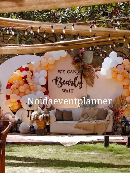 Our trendy boho-chic baby shower decor, with the popular 'We Can Bearly Wait' theme, uses a neutral color palette, pampas grass, and a cozy seating area for a relaxed celebration.
