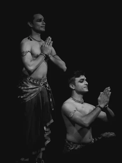 A black and white photo from 'ATAH', capturing a moment of prayer or reverence.