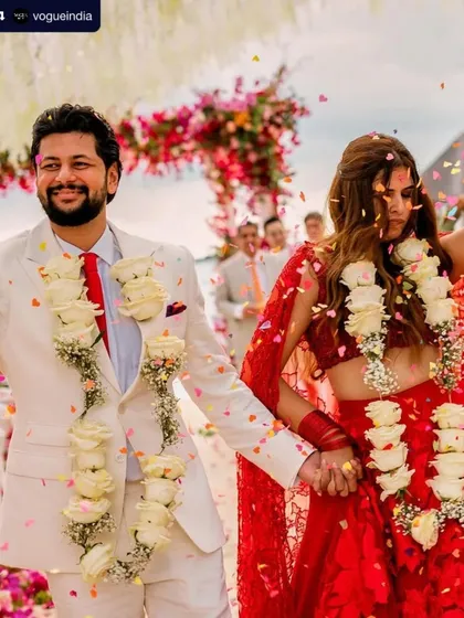 The happy couple after their beach ceremony. Her makeup was designed to be fresh, natural, and weather-proof for the seaside celebration.