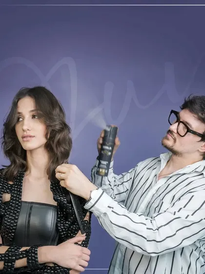 Jon Wilsdon applies a finishing spray to the 'Lucie' cut. This action shot emphasizes the final, crucial steps of styling that lock in the look and ensure its longevity, a key skill for any professional stylist.
