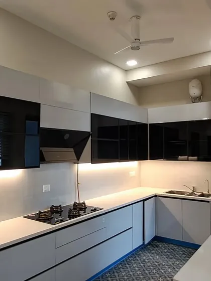 A glimpse into a recently completed project at Paras Quartier, Gurgaon. This modular kitchen showcases a sleek, two-tone design with handleless cabinets, under-cabinet lighting, and a perfectly integrated hob and sink, creating a clean and highly functional cooking space.
