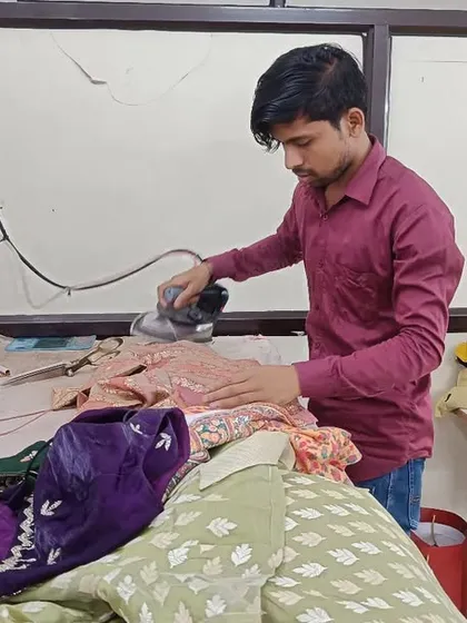 The finishing touches are just as important as the first stitch. My artisan is carefully ironing a newly created garment, ensuring every panel and seam is perfectly pressed for a flawless, professional finish before it's delivered to you.