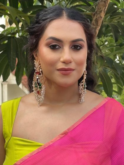 A close-up on the dramatic eye makeup and statement chandelier earrings.