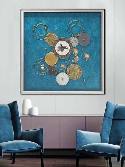 This abstract shadow box uses a cool blue textured background with layered discs in gold, silver, and grey. A central horse motif adds a touch of classical elegance to the modern design.
