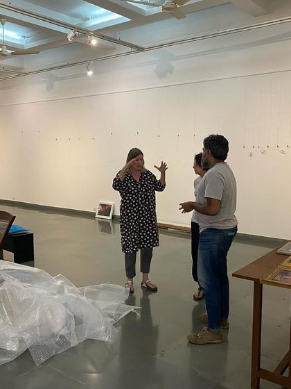 The artist, Clare Arni, in discussion with the team during the setup.