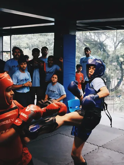Two young warriors exchange kicks during our in-house club wars tournament.