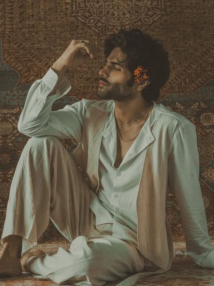 A moody, artistic shot highlighting the intricate craftsmanship of the garment, which mirrors the delicate emotions of the ghazal it was inspired by.