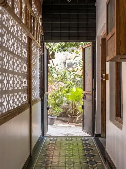 A view from the studio hallway into the garden. The original jaali work on the wall casts beautiful shadows as the light changes throughout the day. It’s these small, preserved details that give the space its unique character and charm.