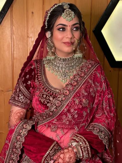 A portrait of regal beauty. The makeup enhances her features, creating a look that is both powerful and graceful, fit for a modern-day queen on her wedding day.