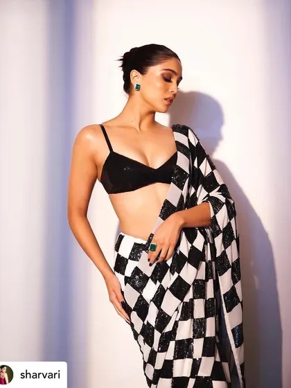 A full-body shot that emphasizes the modern and edgy silhouette. The makeup adds to the overall powerful and confident vibe.