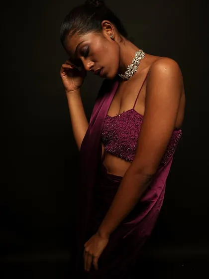 A moody and artistic shot. The makeup, especially the hint of purple on the eyes, adds to the dramatic and emotional feel of the photograph.
