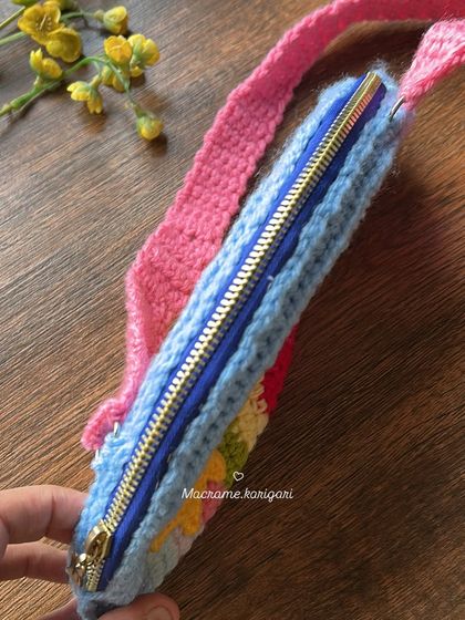 This view shows the slim profile and the quality zipper of our kids' rainbow crochet bag, making it easy for little hands to open and close.