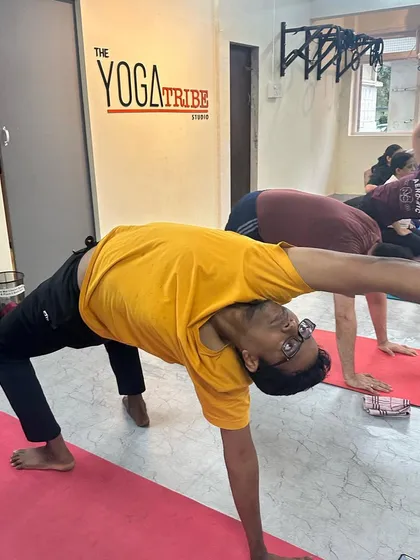 A student finds joy in Camatkarasana (Wild Thing), a beautiful heart-opening pose that embodies the freedom and energy we cultivate in our practice.