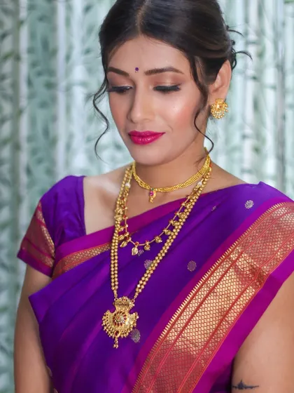 The soft, romantic feel of this look is created by the combination of the hairstyle, makeup, and the elegant drape of the saree.