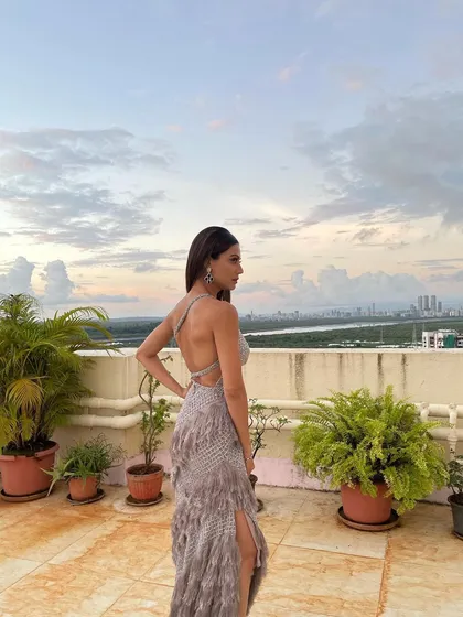 From the back, you can see how the sleek hair contrasts with the textured gown. This kind of celebrity hairstyling is about creating balance in the overall look.