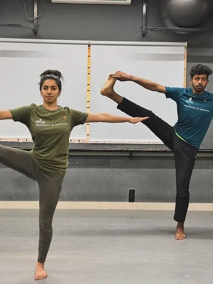 Fitness can be a beautiful partnership. This partner yoga pose, an extended hand-to-big-toe pose, not only builds strength and flexibility but also trust and connection.