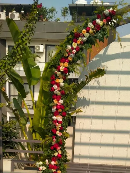 A close-up of the beautiful floral garland, showcasing the variety of fresh roses and greenery used to create the arch.