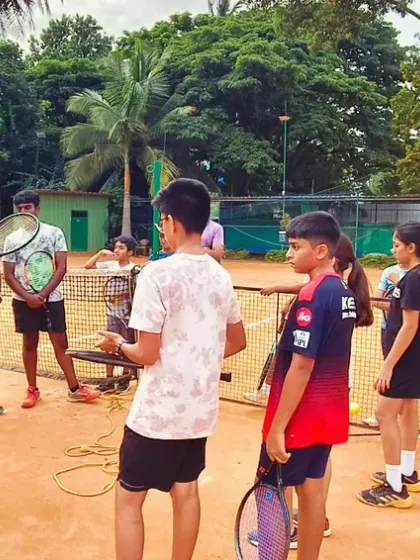 We believe in focused coaching. Here, one of our coaches is giving specific instructions to our advanced batch, ensuring every player gets the personal attention needed to improve their technique.