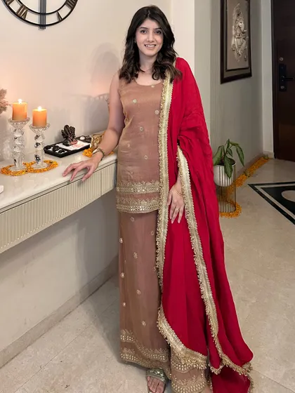 Another one of my favorite festive outfits. This elegant brown suit set with gold embroidery and a vibrant red dupatta is perfect for a Diwali celebration at home.