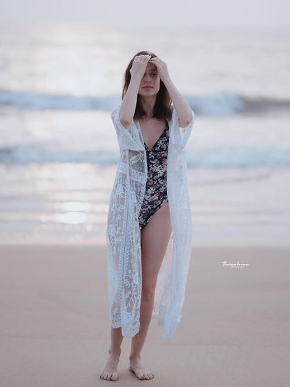 This image captures a thoughtful, in-between moment during the beach shoot. These candid shots often have the most authentic feel.