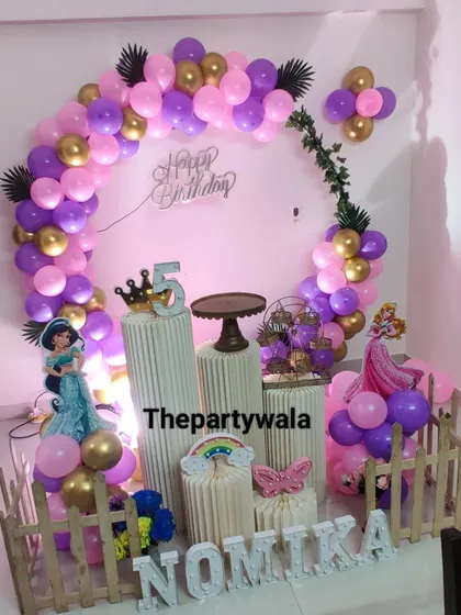 This princess party setup uses a lovely combination of purple, pink, and gold balloons. The character cutouts and props are arranged perfectly for a magical celebration.