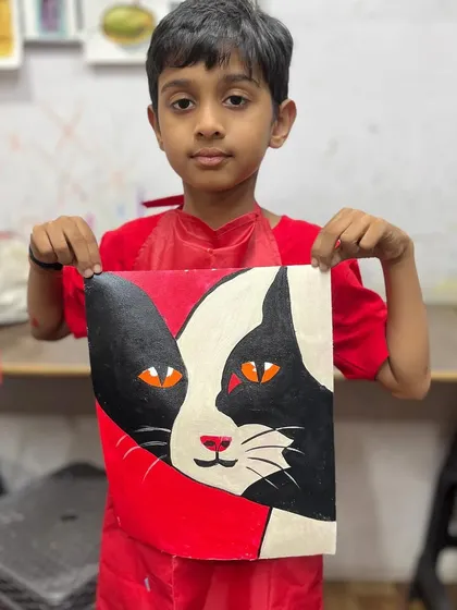 Matching his shirt to his artwork. This student's red and black cat painting is a great example of the bold, graphic style we explored in this class.