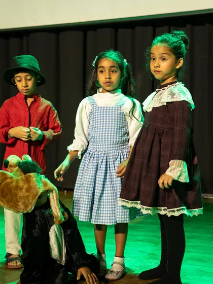 A group of actors reacting to a dramatic event on stage. This shows their ability to listen, stay in character, and respond as an ensemble.