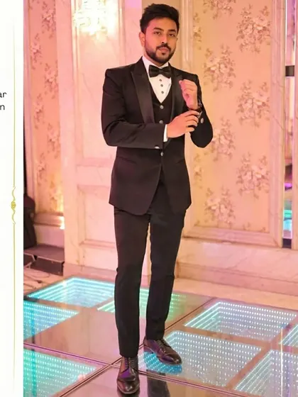 Here is a client looking dapper in a classic black three-piece tuxedo. The perfect fit and satin lapels make this a go-to choice for any formal occasion, from weddings to galas.