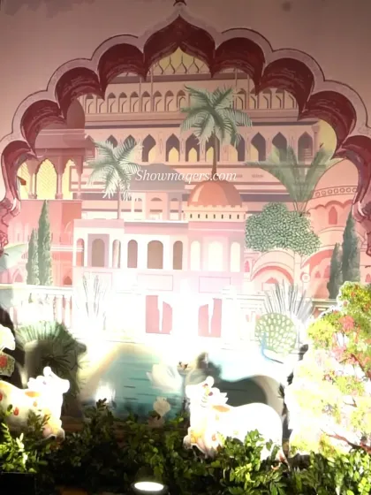 A beautiful backdrop featuring Pichwai art, a traditional style of painting, depicting cows and lush scenery, adding an artistic touch to the Mehendi.